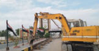 Excavator working beside a bridge structure